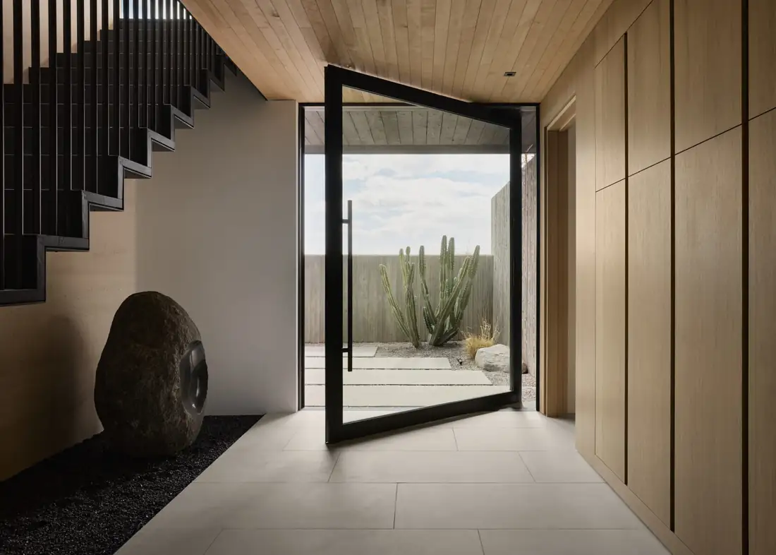 Pivot entry opening to a desert courtyard